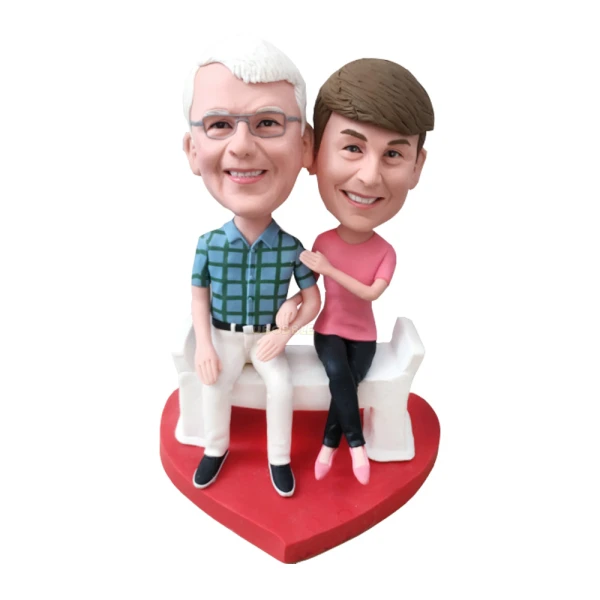 Custom Bobblehead cake toppers, Couple sitting on chair holding hands